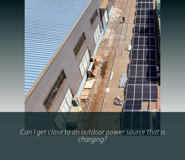 Can I get close to an outdoor power source that is charging?